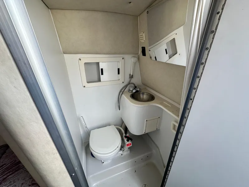 Slide: The Image of 1994 Crownline 250 CR boat bathroom with toilet and sink. - 17