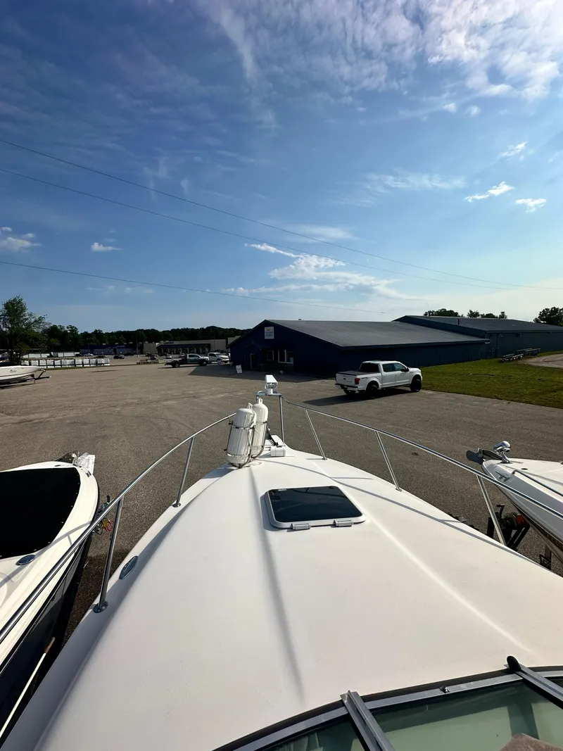 Slide: The Image of 1994 Crownline 250 CR boat docked under a clear blue sky. - 19