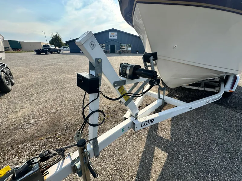 Slide: The Image of Crownline 250 CR 1994 boat on trailer in parking lot. - 20