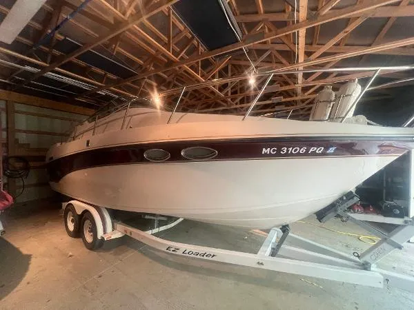 Slide: The Image of Crownline 250 CR 1994 boat on trailer in a garage. - 21