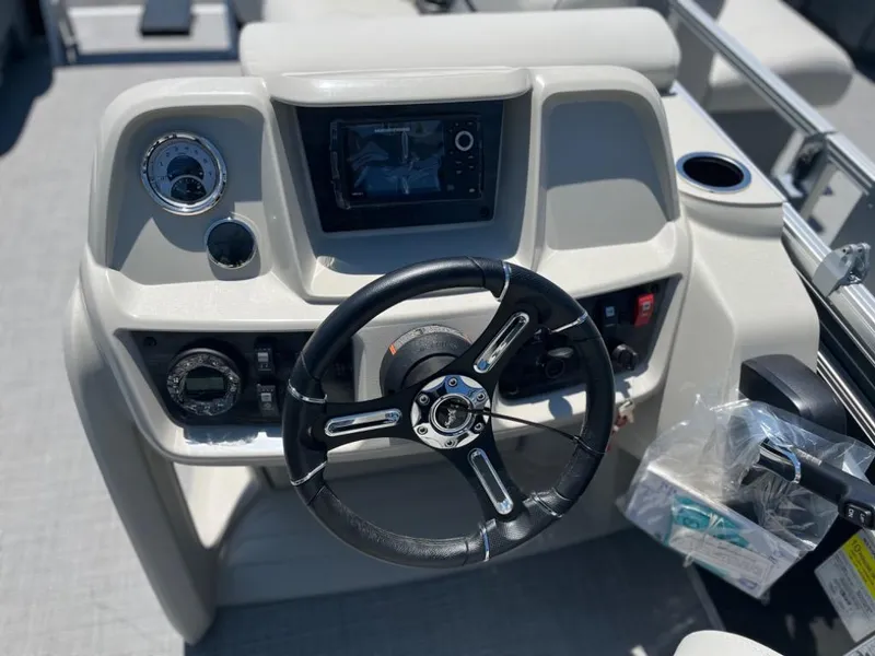 Slide: The Image of 2024 SunChaser Vista Fish 20 boat dashboard with steering wheel and control panel. - 8