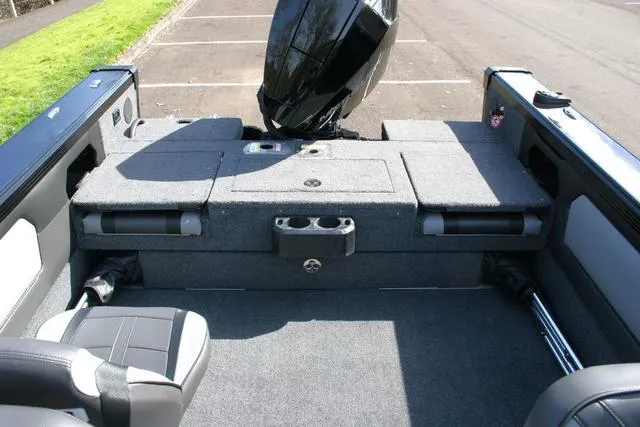 Slide: The Image of 2024 Lund 1975 Tyee Sport boat interior with motor and seating. - 10