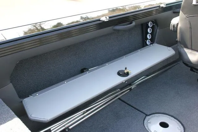 Slide: The Image of Interior of 2024 Lund 1975 Tyee Sport boat with rod storage compartment. - 14