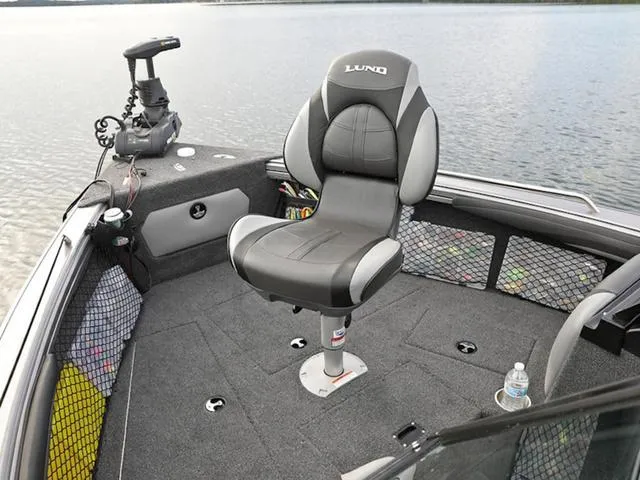 Slide: The Image of 2024 Lund 1975 Tyee Sport boat interior with captain's chair and fishing equipment. - 20