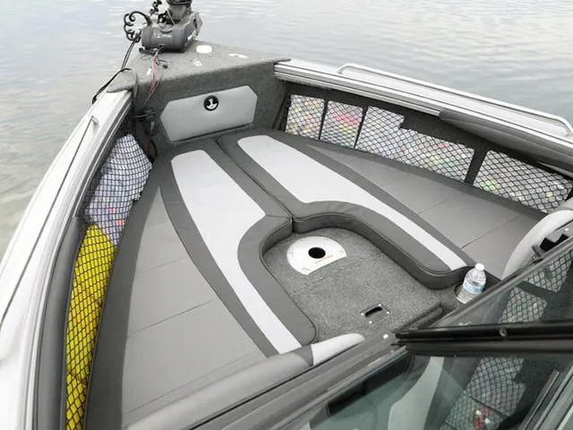 Slide: The Image of 2024 Lund 1975 Tyee Sport boat interior with cushioned seating and storage nets. - 21