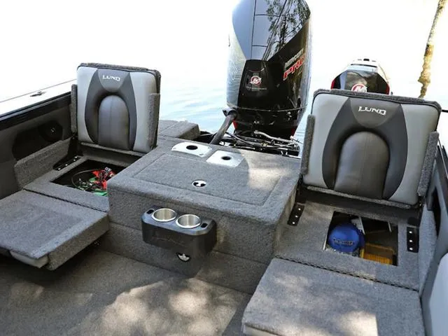 Slide: The Image of Interior of 2024 Lund 1975 Tyee Sport boat with seating and storage compartments. - 22