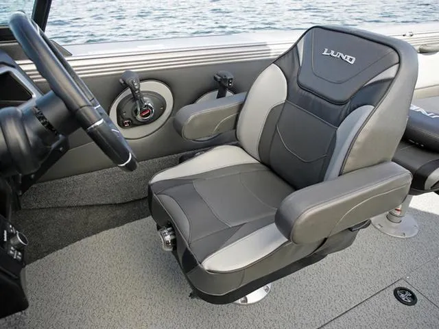 Slide: The Image of 2024 Lund 1975 Tyee Sport boat interior with comfortable captain's chair. - 24