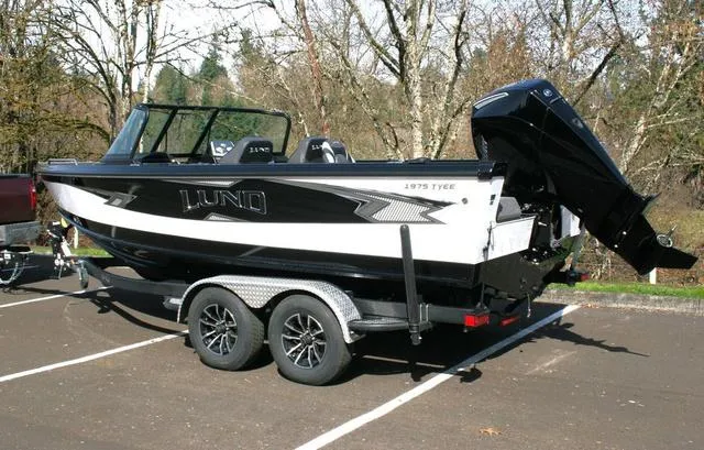 Slide: The Image of 2024 Lund 1975 Tyee Sport boat on a trailer in a parking lot. - 3