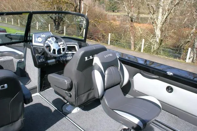 Slide: The Image of Interior of 2024 Lund 1975 Tyee Sport boat with modern seating and steering console. - 6