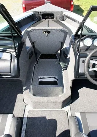 Slide: The Image of 2024 Lund 1875 Crossover XS Sport boat interior with open storage compartments. - 10