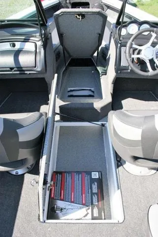 Slide: The Image of 2024 Lund 1875 Crossover XS Sport boat interior with storage compartments and seating. - 11