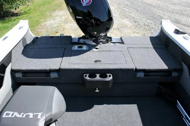 Slide: The Image of 2024 Lund 1875 Crossover XS Sport boat interior with motor and seating. - 12