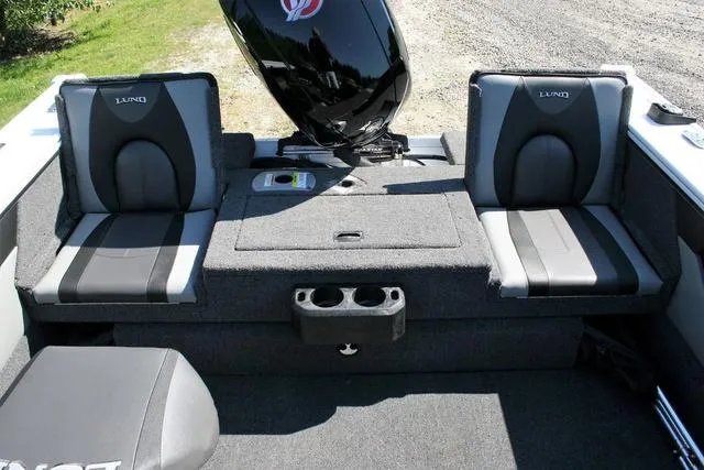 Slide: The Image of 2024 Lund 1875 Crossover XS Sport boat interior with dual seats and motor. - 13