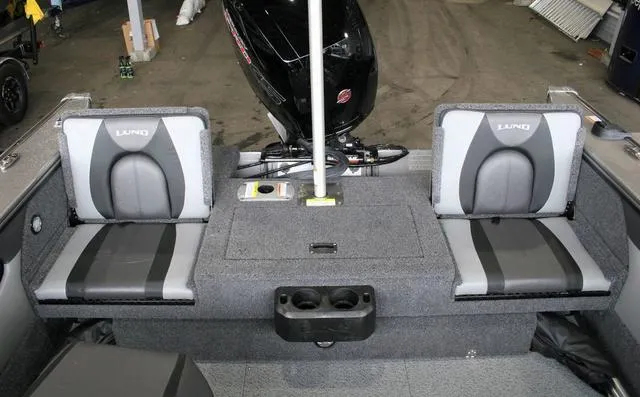 Slide: The Image of 2024 Lund 1875 Crossover XS Sport boat interior with dual seats and motor. - 15
