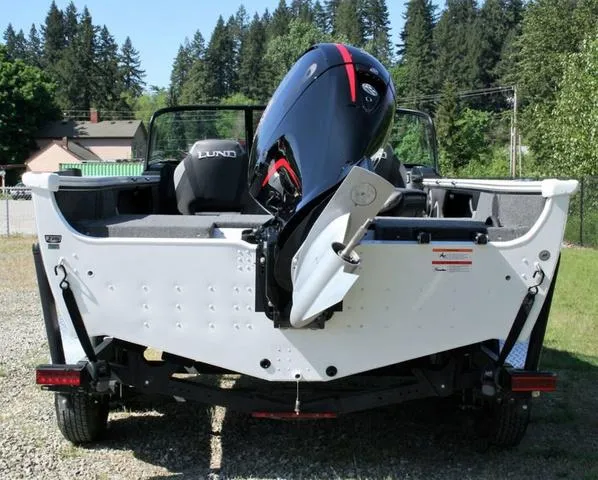 Slide: The Image of 2024 Lund 1875 Crossover XS Sport boat with outboard motor, rear view. - 4