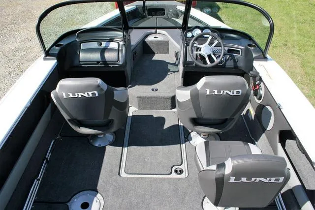 Slide: The Image of 2024 Lund 1875 Crossover XS Sport boat interior with seating and dashboard. - 5