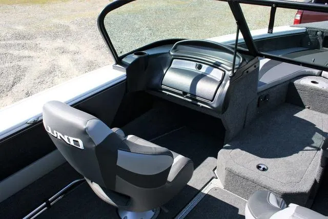 Slide: The Image of 2024 Lund 1875 Crossover XS Sport boat interior with captain's chair and dashboard. - 7