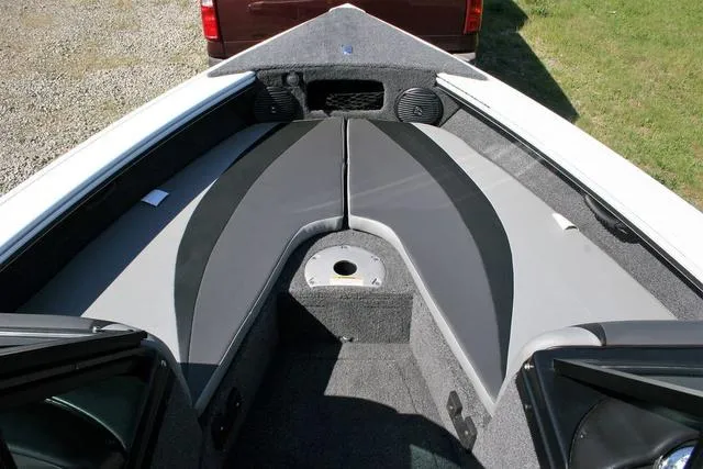 Slide: The Image of 2024 Lund 1875 Crossover XS Sport boat interior with cushioned seating and storage compartments. - 9