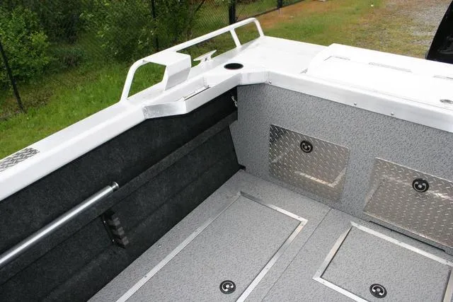 Slide: The Image of 2024 Thunder Jet 210 Luxor Limited boat interior with storage compartments. - 12