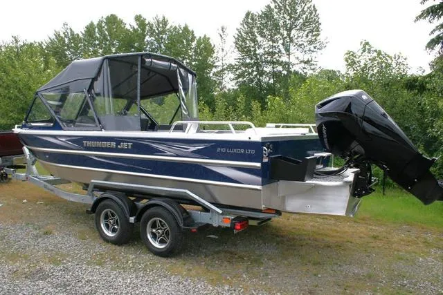 Slide: The Image of 2024 Thunder Jet 210 Luxor Limited boat on a trailer with outboard motor. - 3
