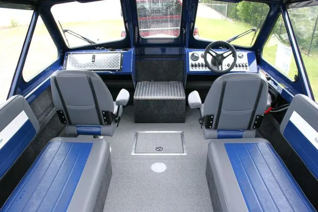 Slide: The Image of Interior of 2024 Thunder Jet 210 Luxor Limited boat with blue and gray seating. - 5