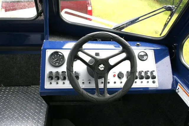 Slide: The Image of 2024 Thunder Jet 210 Luxor Limited boat dashboard with steering wheel and control panel. - 8