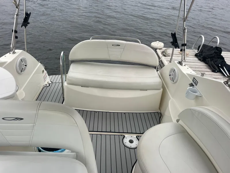 Slide: The Image of 2007 Maxum 2400 SE boat interior with white seating and gray flooring. - 13