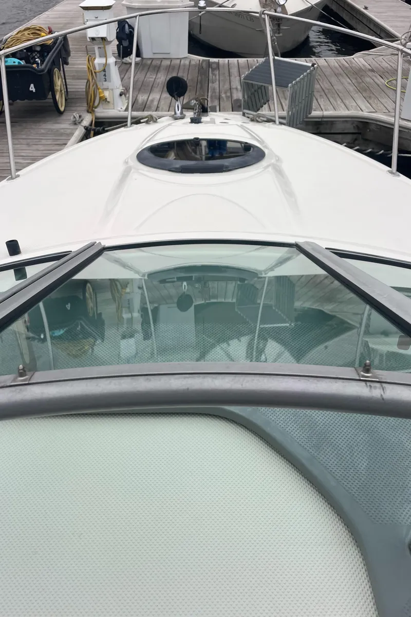 Slide: The Image of 2007 Maxum 2400 SE boat docked, view from bow with windshield and hatch. - 14