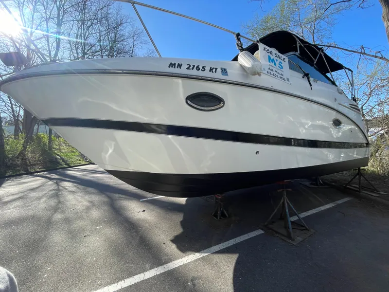 Slide: The Image of 2007 Maxum 2400 SE boat on stands, parked outdoors, with a "For Sale" sign. - 17