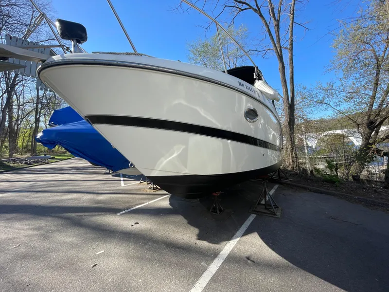 Slide: The Image of 2007 Maxum 2400 SE boat on stands in a sunny outdoor setting. - 2