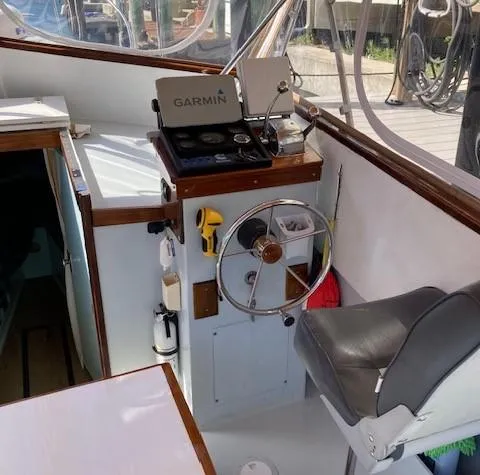 Slide: The Image of Interior of a 1968 Dyer 29 Bass Boat with steering wheel and Garmin device. - 11
