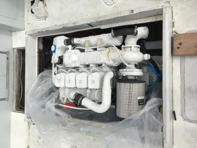 Slide: The Image of Engine of a 1968 Dyer 29 Bass Boat, painted white. - 14