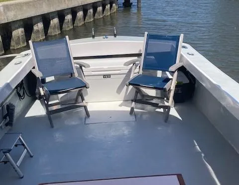 Slide: The Image of Interior of a 1968 Dyer 29 Bass Boat with two blue chairs. - 16