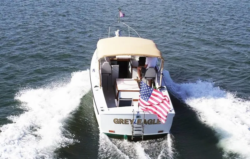 Slide: The Image of 1968 Dyer 29 Bass Boat cruising with American flag. - 2