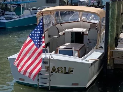 Slide: The Image of 1968 Dyer 29 Bass Boat with American flag in harbor. - 21