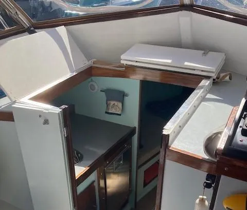 Slide: The Image of Interior of a 1968 Dyer 29 Bass Boat with kitchen and sleeping area. - 5