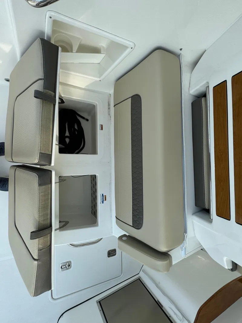 Slide: The Image of 2021 Pursuit DC 365 boat interior with storage compartments and seating. - 12