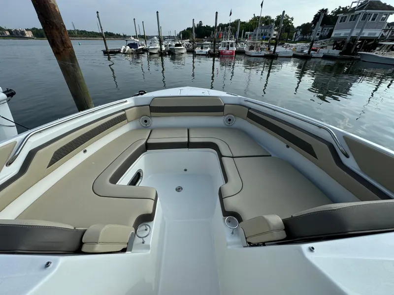 Slide: The Image of 2021 Pursuit DC 365 boat with spacious seating at a marina. - 18