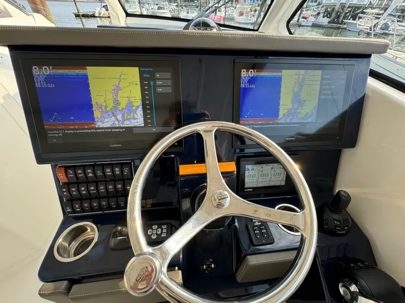 Slide: The Image of 2021 Pursuit DC 365 helm with dual navigation screens and steering wheel. - 6