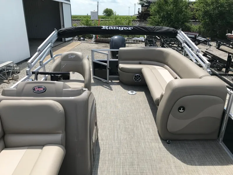 Slide: The Image of 2024 Ranger Reata 200C pontoon boat with beige seating and spacious deck. - 10