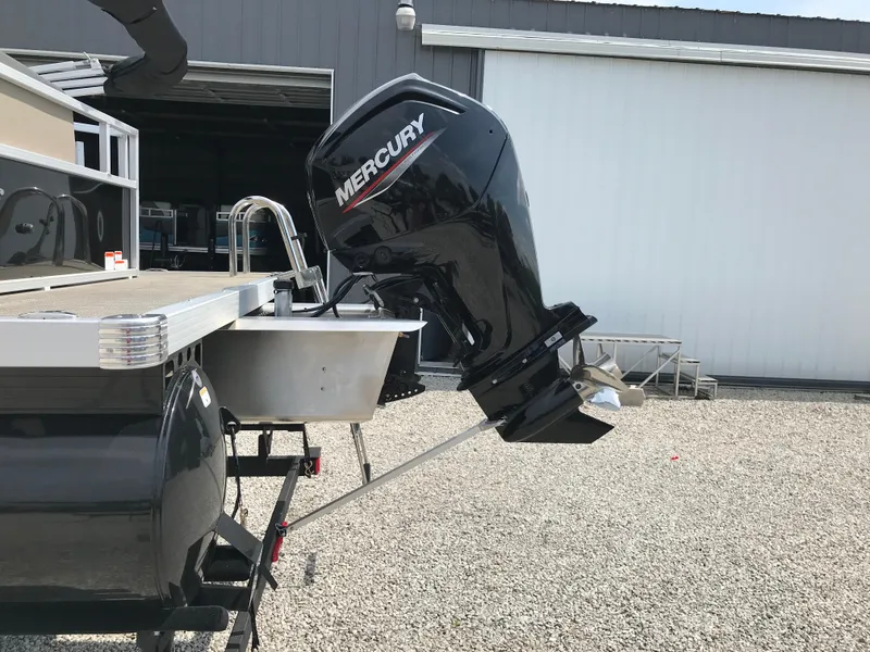 Slide: The Image of 2024 Ranger Reata 200C with Mercury outboard motor in a boatyard. - 5