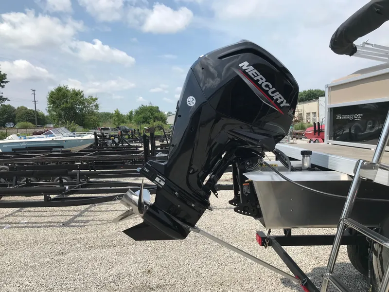 Slide: The Image of 2024 Ranger Reata 200C boat with Mercury outboard motor in a marina. - 6