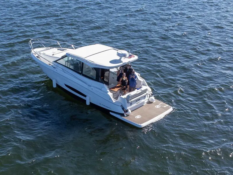 The Image of 2023 Regal Grande Coupe boat cruising on open water. - 0