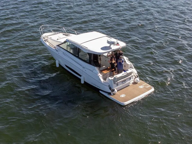 Slide: The Image of 2023 Regal Grande Coupe boat cruising on open water. - 1