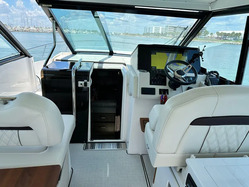 Slide: The Image of 2023 Regal Grande Coupe yacht interior with modern helm and luxurious seating. - 3