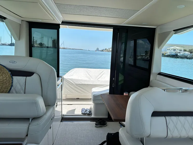 Slide: The Image of Interior view of 2023 Regal Grande Coupe yacht overlooking serene waterfront. - 10