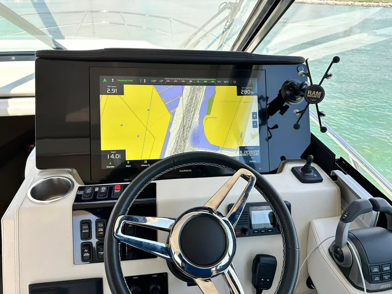 Slide: The Image of 2023 Regal Grande Coupe dashboard with navigation display and steering wheel. - 2