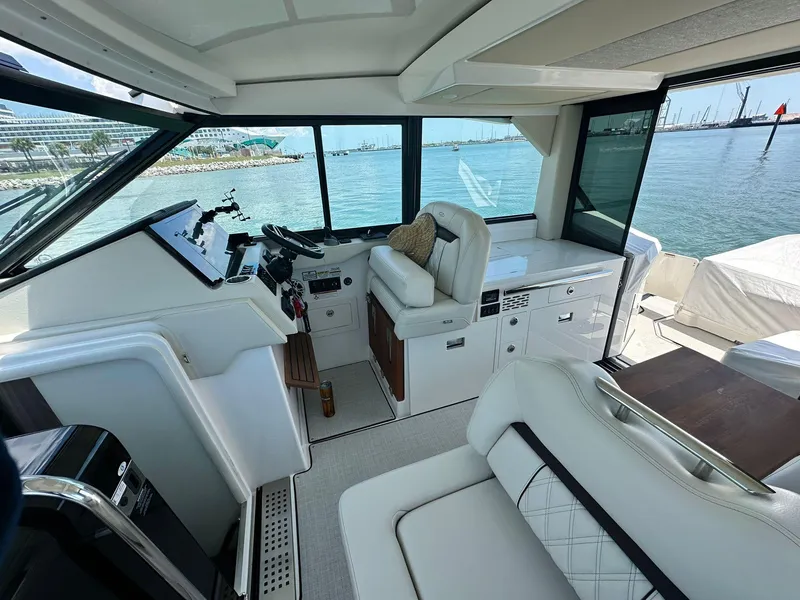 Slide: The Image of Luxurious interior of 2023 Regal Grande Coupe yacht with plush seating and scenic ocean view. - 4