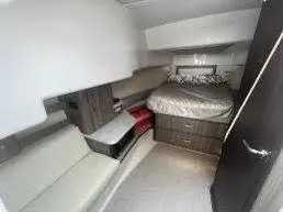 Slide: The Image of 2023 Regal Grande Coupe interior cabin with bed and seating area. - 8