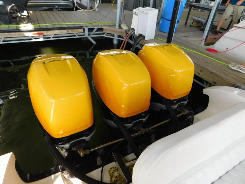 Slide: The Image of Three yellow outboard motors on a 2004 Fountain 38 Sportfish CC boat. - 11